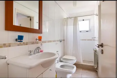 a bathroom with a sink and a toilet and a mirror at Casa D'amico in Villa General Belgrano