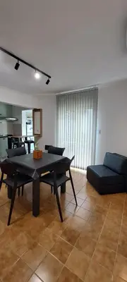 a living room with a table and a couch at Mozzafiato in Cordoba