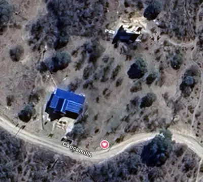 an aerial view of a house with a blue roof at Angel Alpino Cabin in Cuesta Blanca