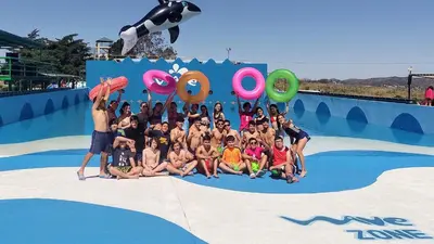 a group of children posing for a picture at a swimming pool at Angel Alpino Cabin in Cuesta Blanca