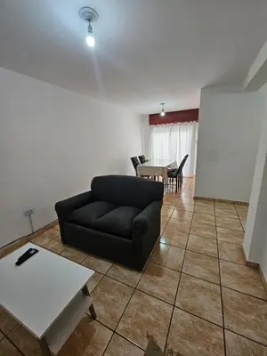a living room with a couch and a table at La Rioja Apartamento in Cordoba