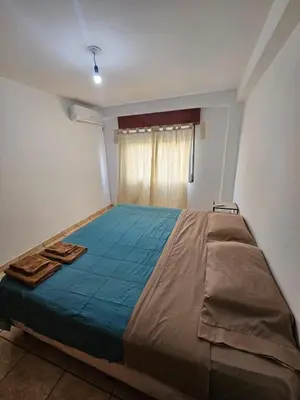 a large bed in a room with a window at La Rioja Apartamento in Cordoba