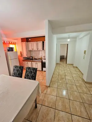 a kitchen with a table and chairs in a room at La Rioja Apartamento in Cordoba
