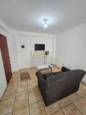 a living room with a couch and a tv at La Rioja Apartamento in Cordoba