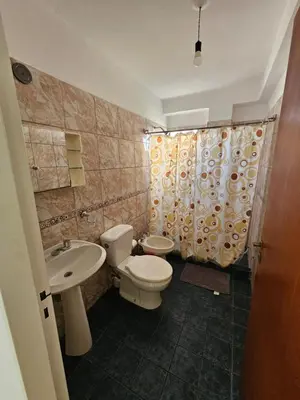 a bathroom with a toilet and a sink at La Rioja Apartamento in Cordoba