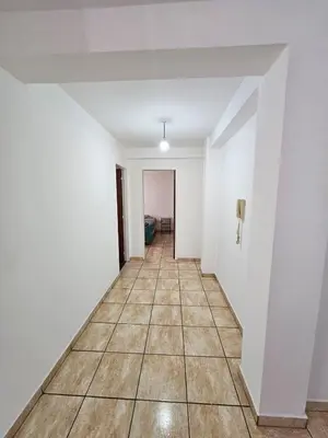 an empty hallway with white walls and a tile floor at La Rioja Apartamento in Cordoba