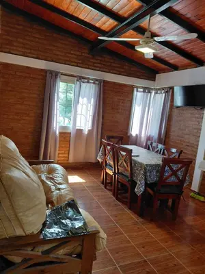 a room with a table and chairs and a dining room at familia olivares in Villa Carlos Paz
