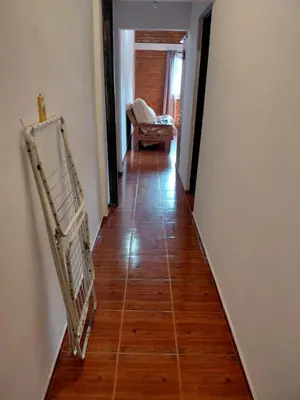 a hallway with a chair and a couch in a room at familia olivares in Villa Carlos Paz
