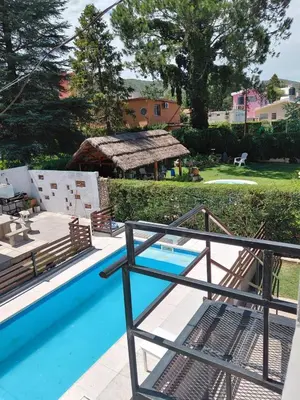 a view of a swimming pool from the balcony of a house at familia olivares in Villa Carlos Paz