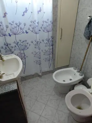 a bathroom with a toilet and a sink at familia olivares in Villa Carlos Paz