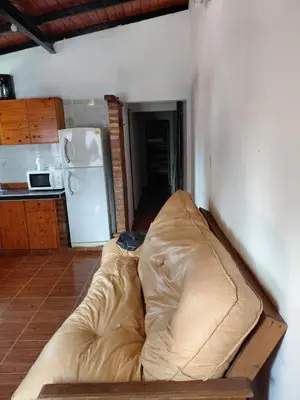 a large couch in a room with a kitchen at familia olivares in Villa Carlos Paz