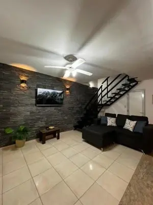 a living room with a couch and a ceiling fan at Mirador Rest House - Casa entera con pileta privada in Bialet Massé