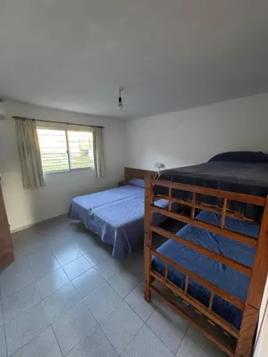 a bedroom with two bunk beds and a window at Cabañas con pileta y aire acondicionado empalme in Villa Carlos Paz