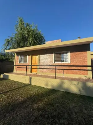 a house with a fence in front of it at Cabañas con pileta y aire acondicionado empalme in Villa Carlos Paz