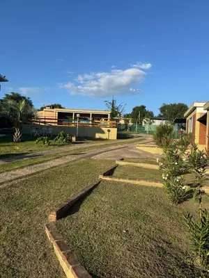 a road in a yard with a building in the background at Cabañas con pileta y aire acondicionado empalme in Villa Carlos Paz