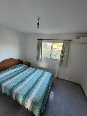 a bedroom with a bed and a window at Cabañas con pileta y aire acondicionado empalme in Villa Carlos Paz