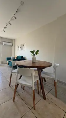 a wooden table and chairs in a living room at Güemes Apartamento in Cordoba