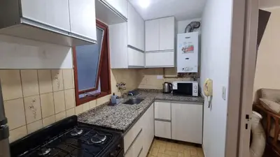 a small kitchen with a stove and a sink at centro apartment in Cordoba