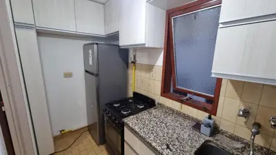 a small kitchen with a stove and a window at centro apartment in Cordoba