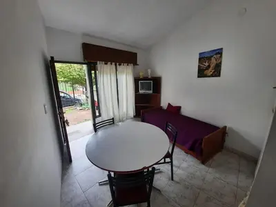 a small living room with a table and a couch at Marisa departamento temporario in Villa Carlos Paz