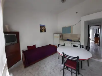 a living room with a table and a couch at Marisa departamento temporario in Villa Carlos Paz