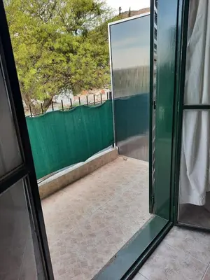a sliding glass door with a view of a patio at Marisa depto temporario in Villa Carlos Paz