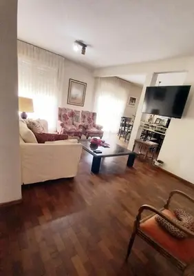 a living room with a white couch and a coffee table at Amplio departamento céntrico con cochera in Río Cuarto