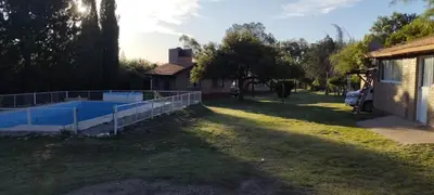a yard with a fence and a swimming pool at Posada Del Galés in Los Molles