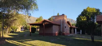 an old brick church with a mountain in the background at Posada Del Galés in Los Molles