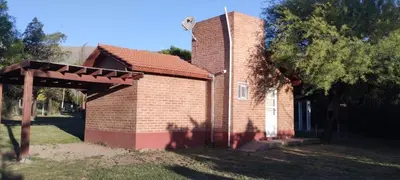 a small brick house with an awning in the yard at Posada Del Galés in Los Molles