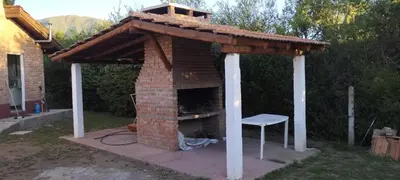 a brick oven with a roof on top of it at Posada Del Galés in Los Molles