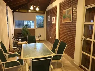 a dining room with a table and chairs at Dúplex Carlos Paz in Villa Carlos Paz