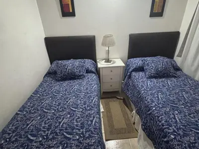 two beds sitting next to each other in a bedroom at Dúplex Carlos Paz in Villa Carlos Paz