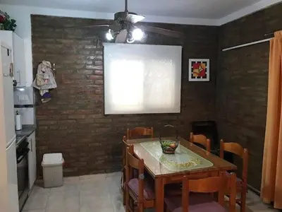 a kitchen with a table and chairs and a window at Dúplex Carlos Paz in Villa Carlos Paz