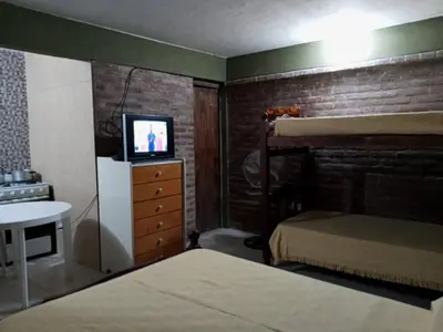 a bedroom with a bunk bed and a tv on a dresser at paprikas in Villa Ciudad Parque