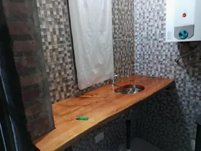 a bathroom with a wooden counter with a sink at paprikas in Villa Ciudad Parque