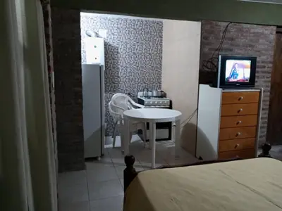 a small room with a table and a refrigerator at paprikas in Villa Ciudad Parque