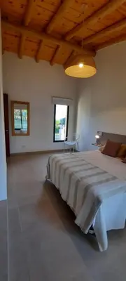 a large bedroom with a large bed in a room at Casa de Campo Roca - Exclusivo para Parejas in Villa Cura Brochero