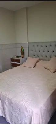 a bedroom with a large white bed and a dresser at Departamento Balcarce 455 in Cordoba