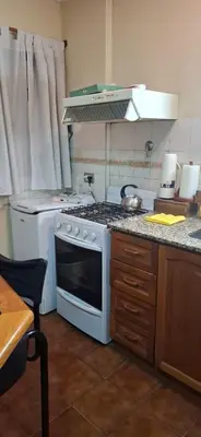 a kitchen with a stove top oven in a kitchen at Departamento Balcarce 455 in Cordoba