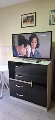 a flat screen tv sitting on top of a dresser at Departamento Balcarce 455 in Cordoba