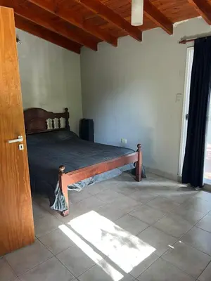 a bedroom with a wooden bed in a room at Siempre verde in El Rincón