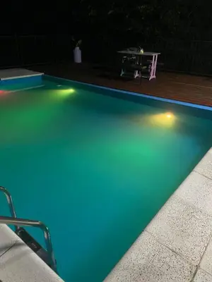 an empty swimming pool at night with a table at Siempre verde in El Rincón