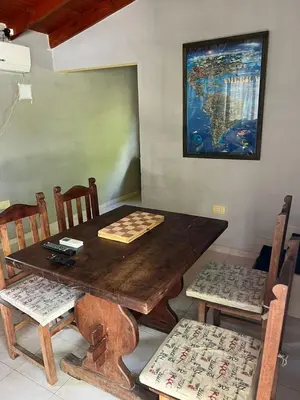 a wooden table and chairs with a chess game on it at Siempre verde in El Rincón