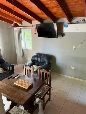 a living room with a table and a couch at Siempre verde in El Rincón