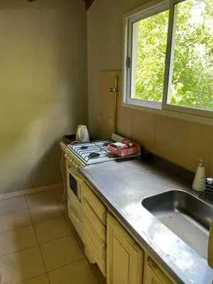 a kitchen with a sink and a stove and a window at Siempre verde in El Rincón