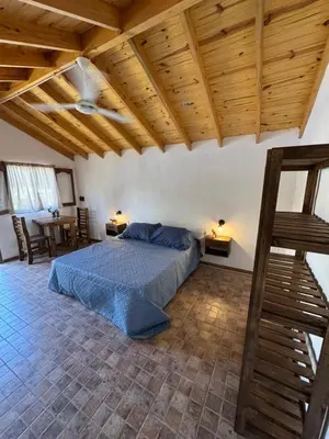 a bedroom with a bed and a wooden ceiling at Gran aldea in Mina Clavero