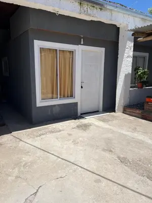 a garage with a white door and a window at La soñada AG in Alta Gracia