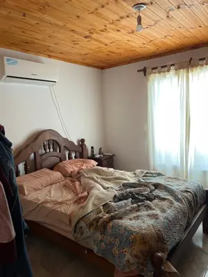 a bedroom with a bed and a wooden ceiling at La soñada AG in Alta Gracia