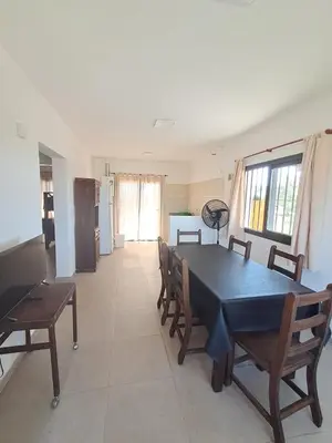 a dining room with a black table and chairs at Mis tres estrellas 2 in Cavalango